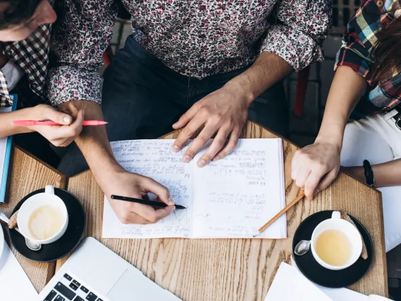 People working on a piece of writing together