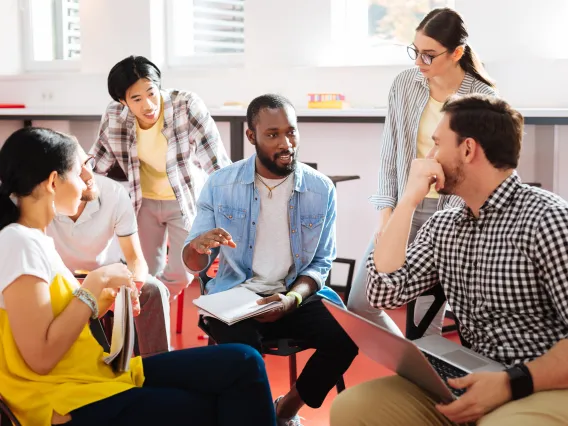 Faculty talking together in a circle