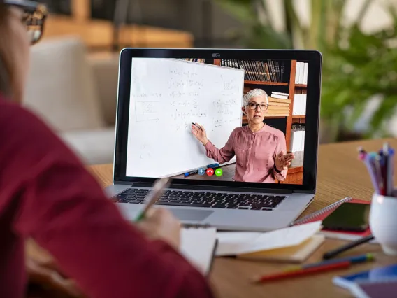 Student learning from a professor on the computer