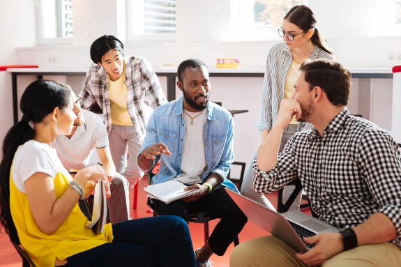 Faculty talking together in a circle